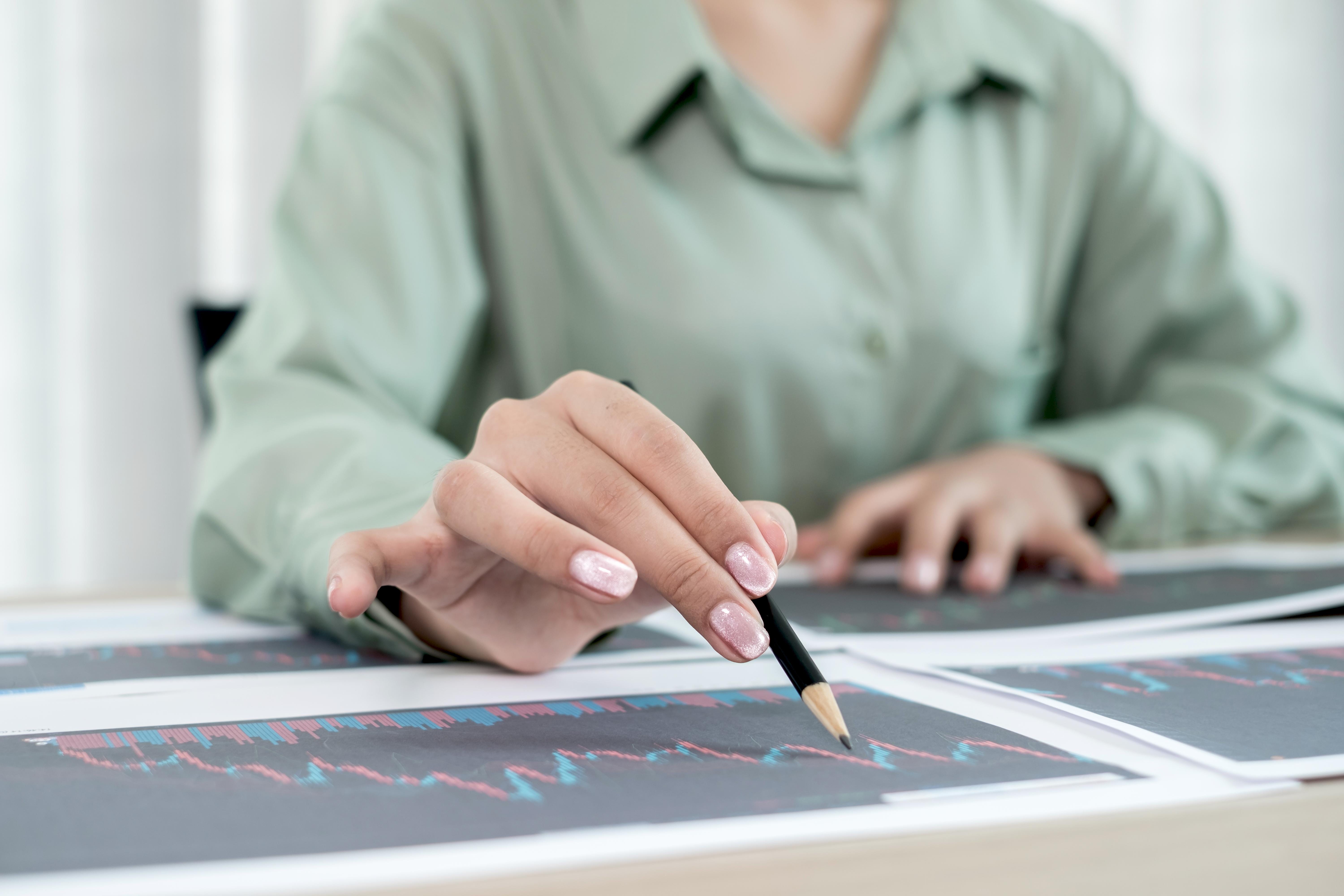 A person viewing financial data on a tablet